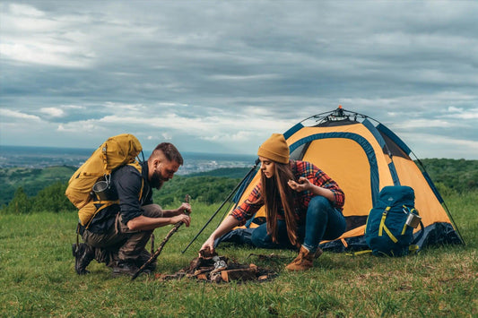 Tent set up in a grassy outdoor area showcasing outdoor hiking basics for novice campers.